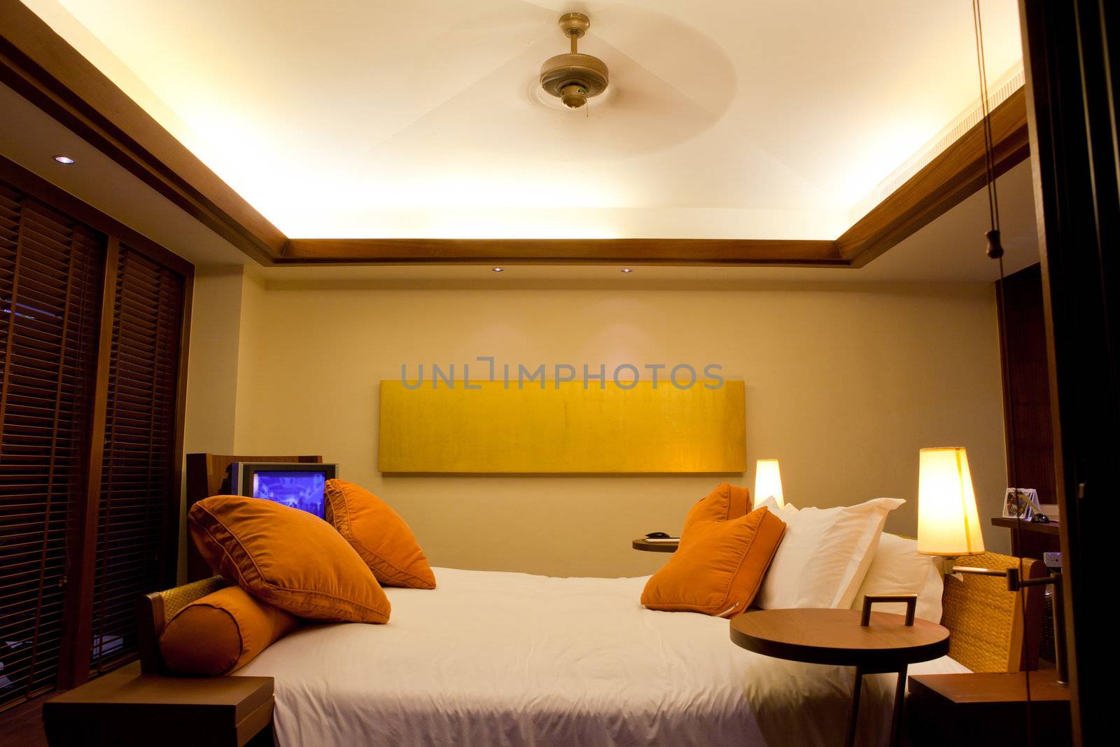 Hotel room in a tropical resort with bed and wooden flooring