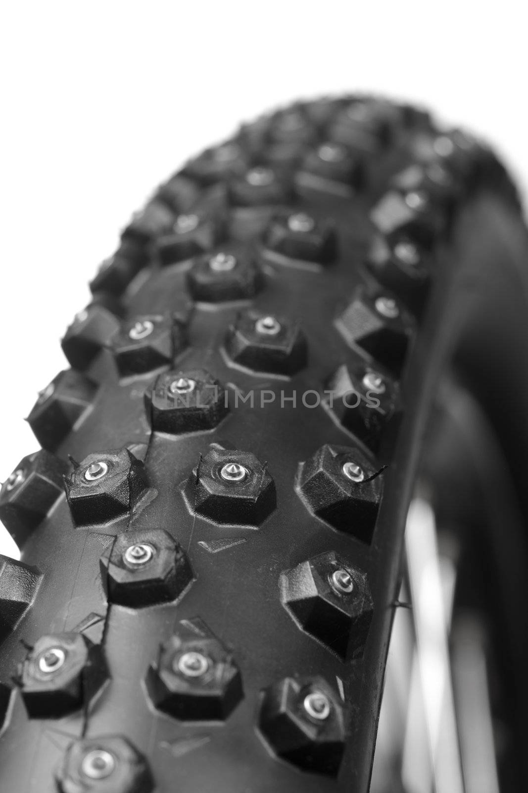 Knobby mountain bike winter tire with spikes close-up