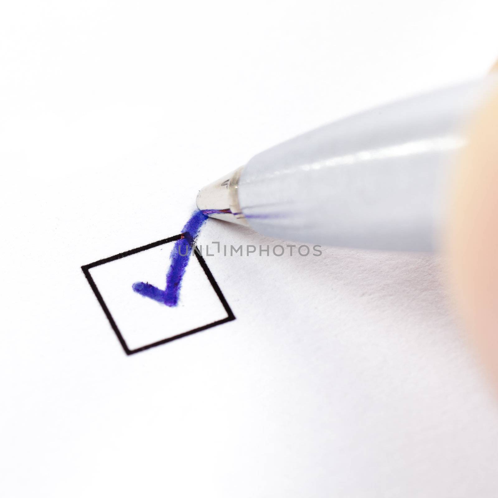 Hand with pen marking a check box