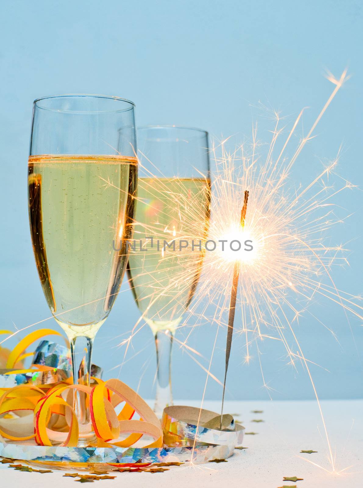 Two glasses of champagne with ribbons and burnning sparkler