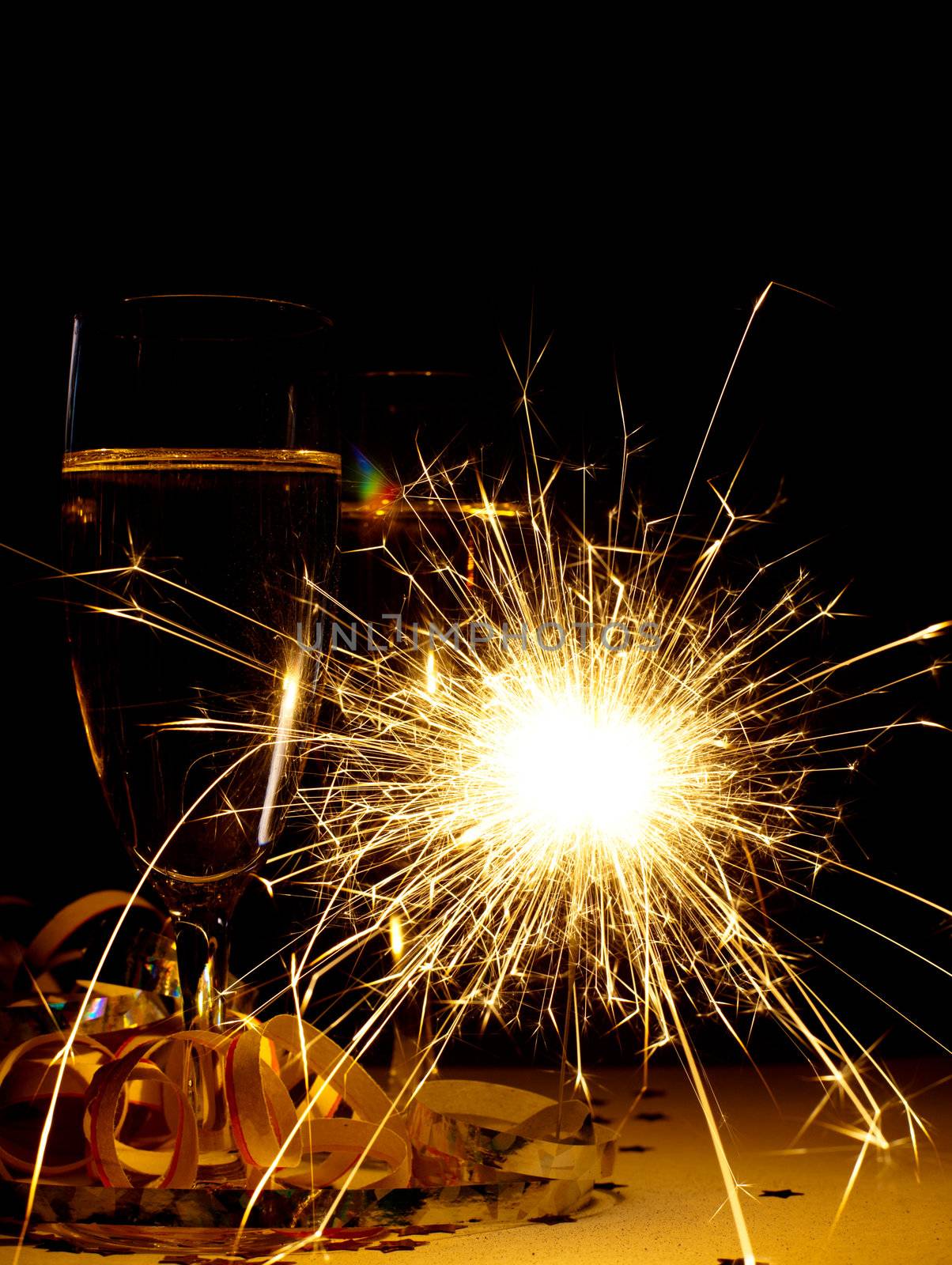 Two glasses of champagne with burnning sparkler