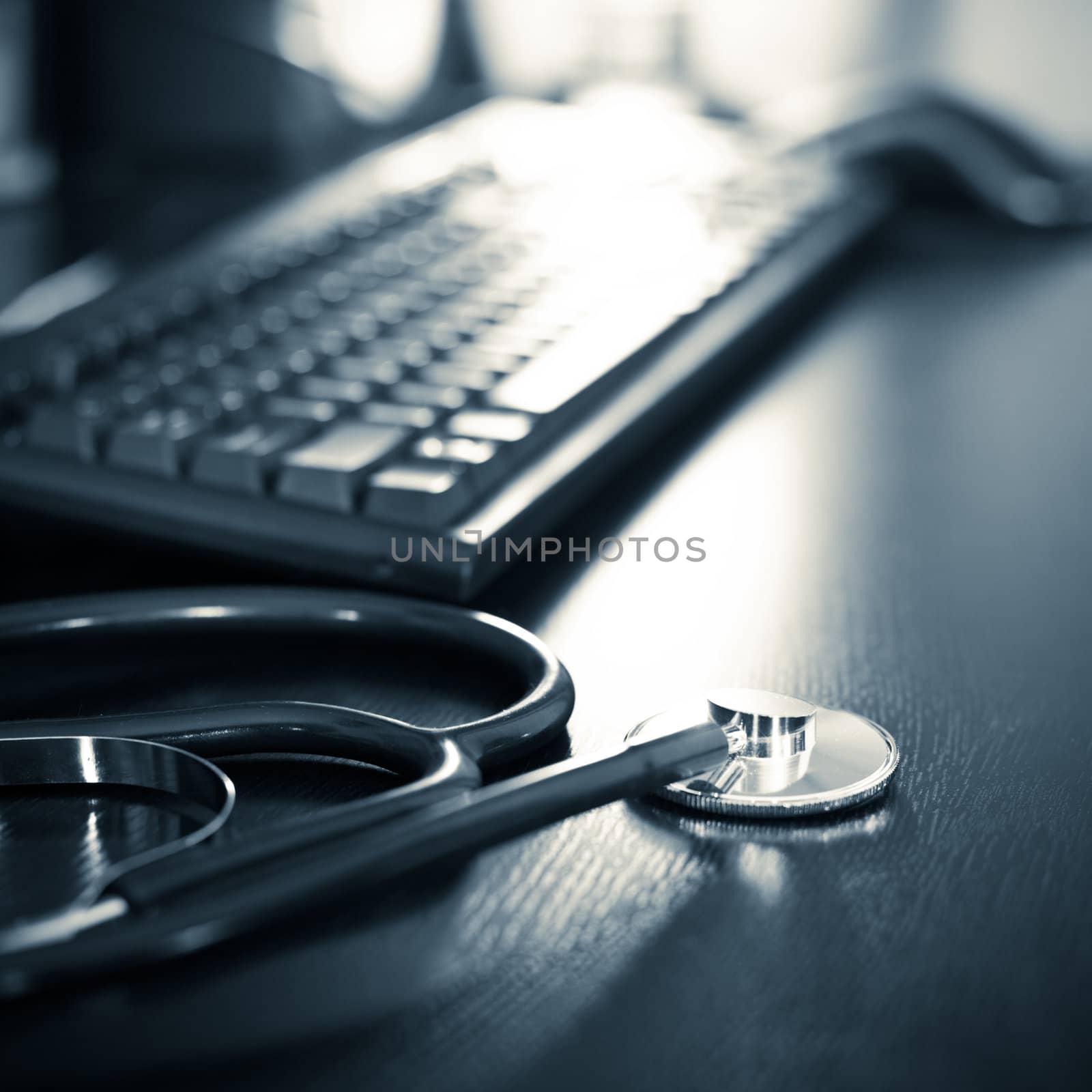 Stethoscope on a table with keyboard, very shallow DOF