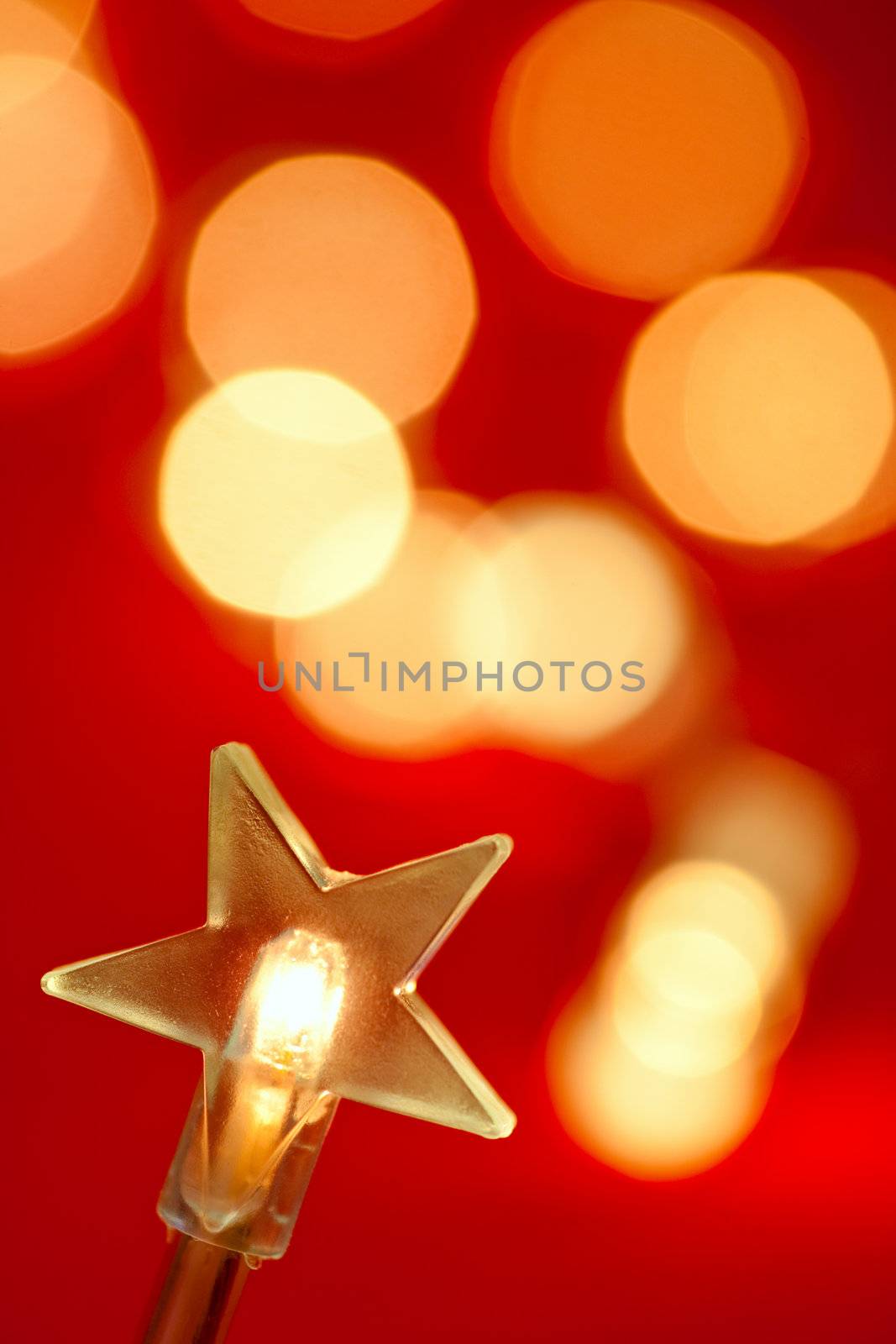 Star shaped Christmas light with blured lights in background, very shallow DOF