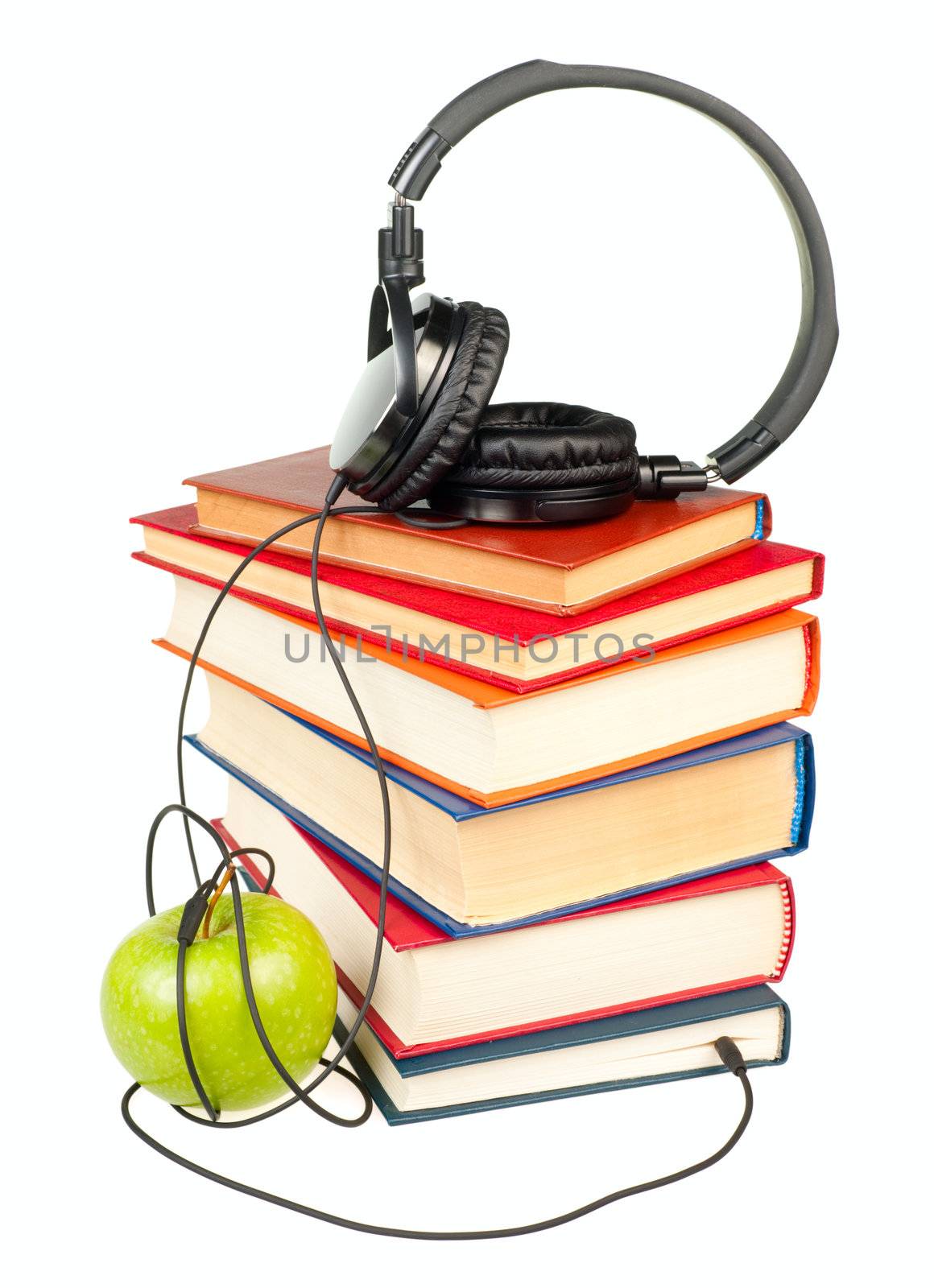 HI-Fi headphones on stack of old books with green apple on white background