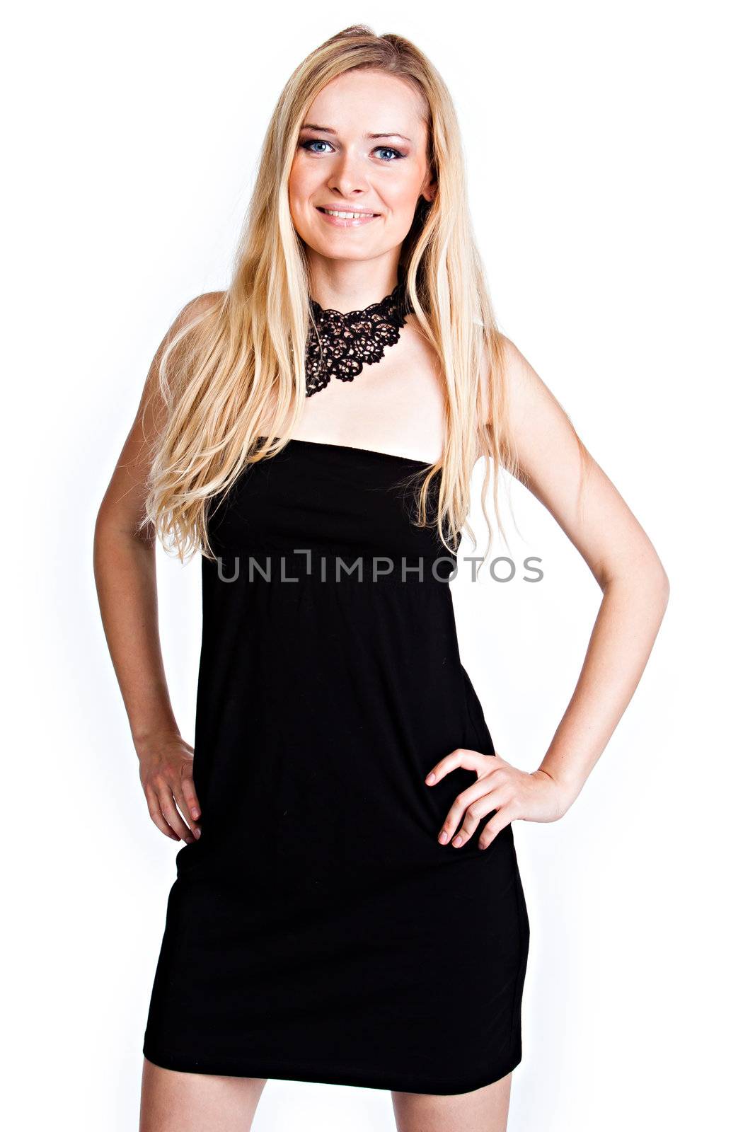 Young and beautiful woman with blond hair in a black cocktail dress on a white background isolated