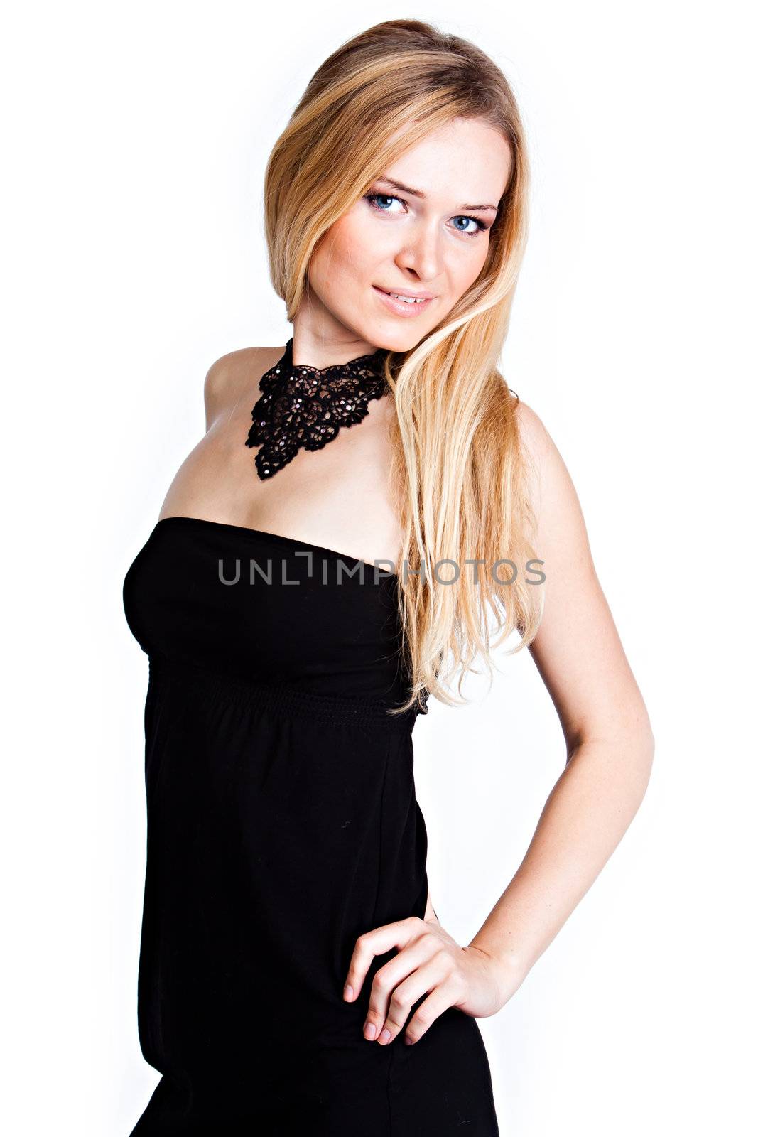 Young and beautiful woman with blond hair in a black cocktail dress on a white background isolated