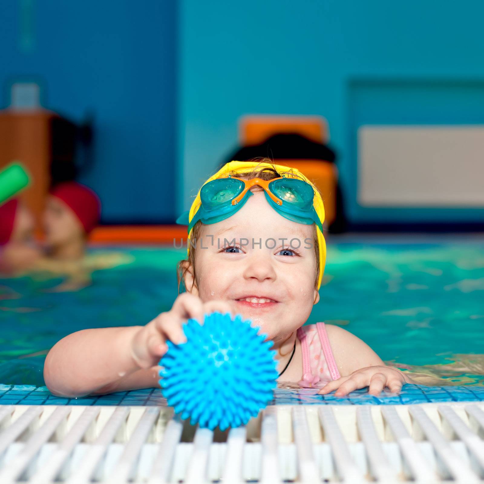 Child in a swimming pool by naumoid