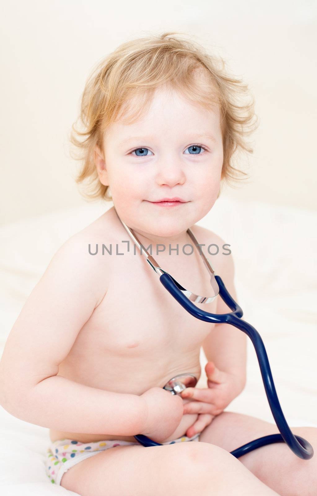 Cheerful baby girl with stethoscope
