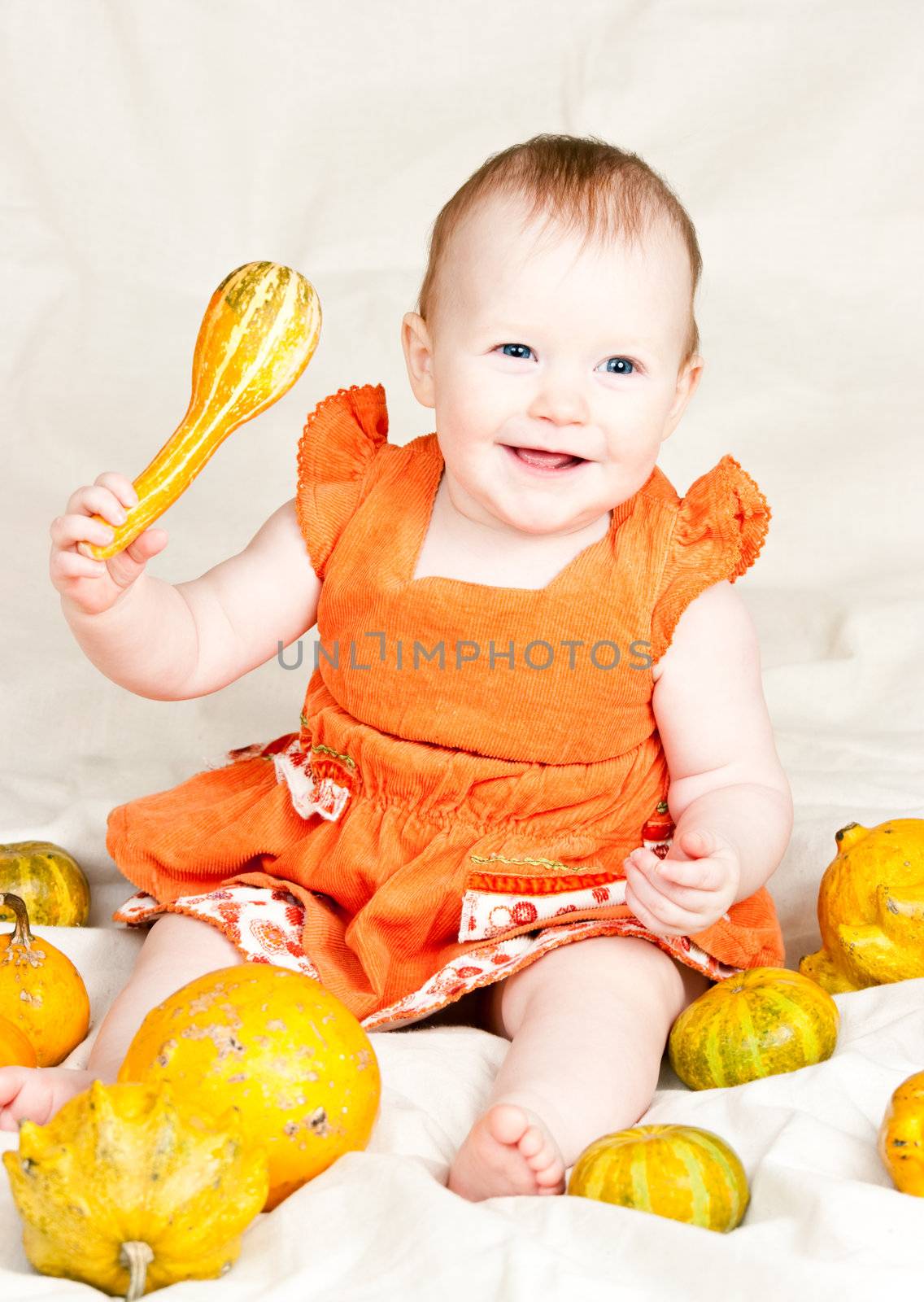 Little baby girl playing with calabash pumpkin
