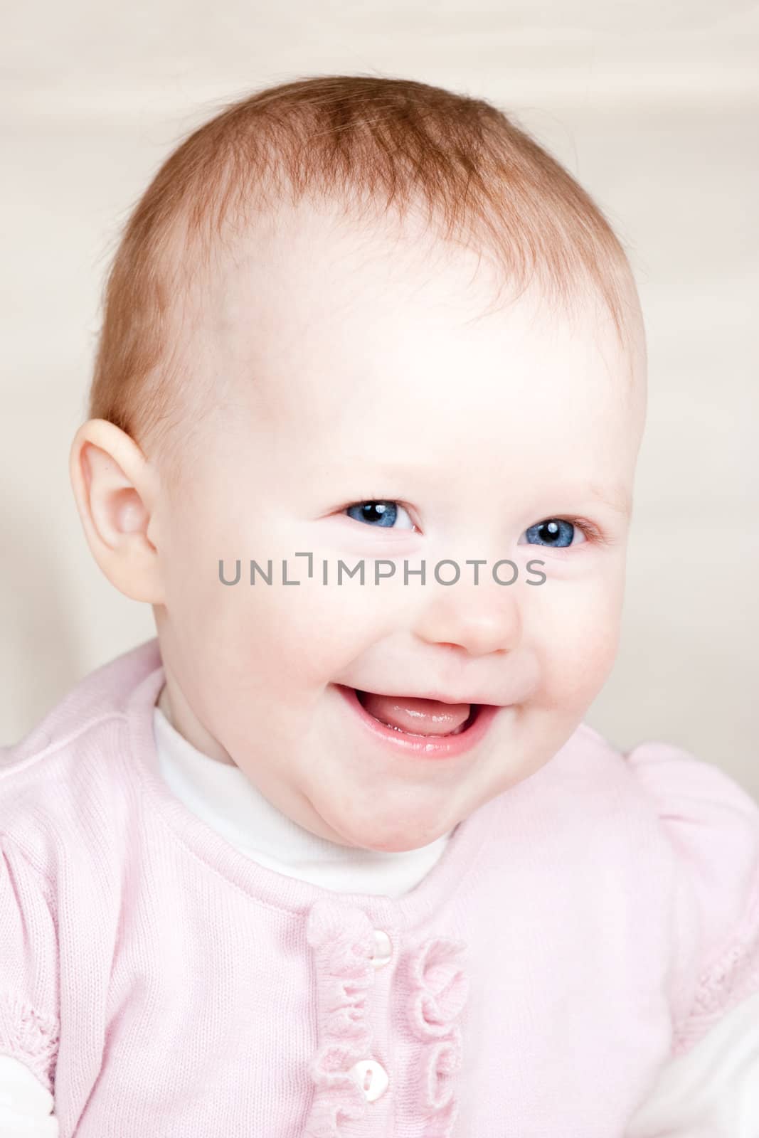 Portrait of cheerful blue-eyed baby girl