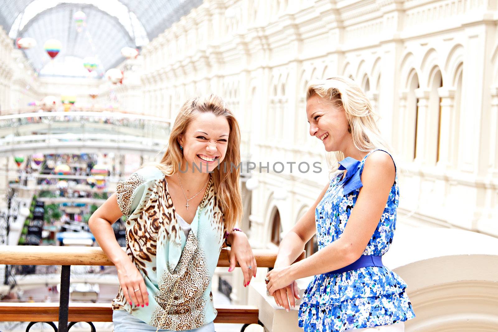 Two young beautiful woman in a shopping center