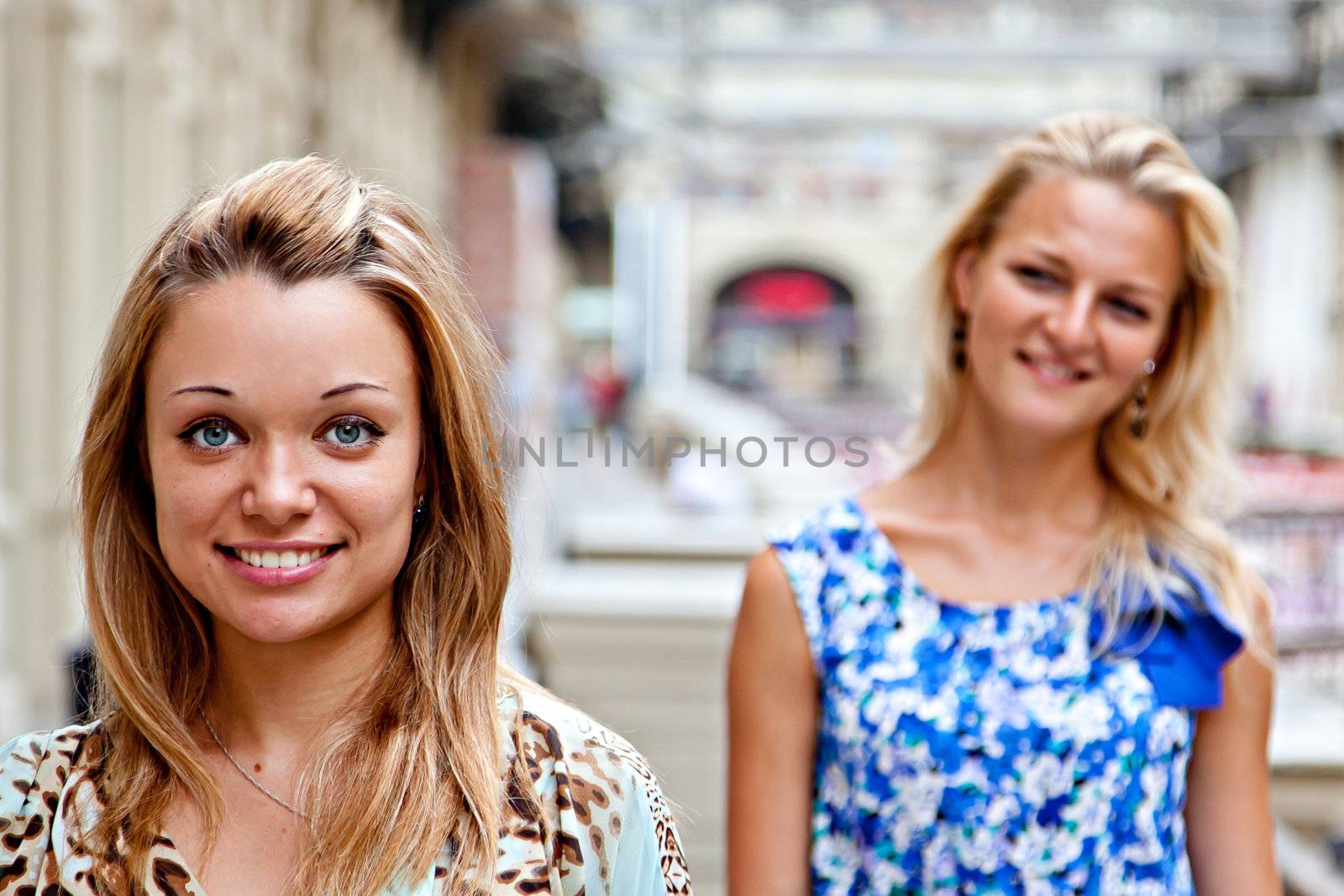 Two young beautiful woman in a shopping center