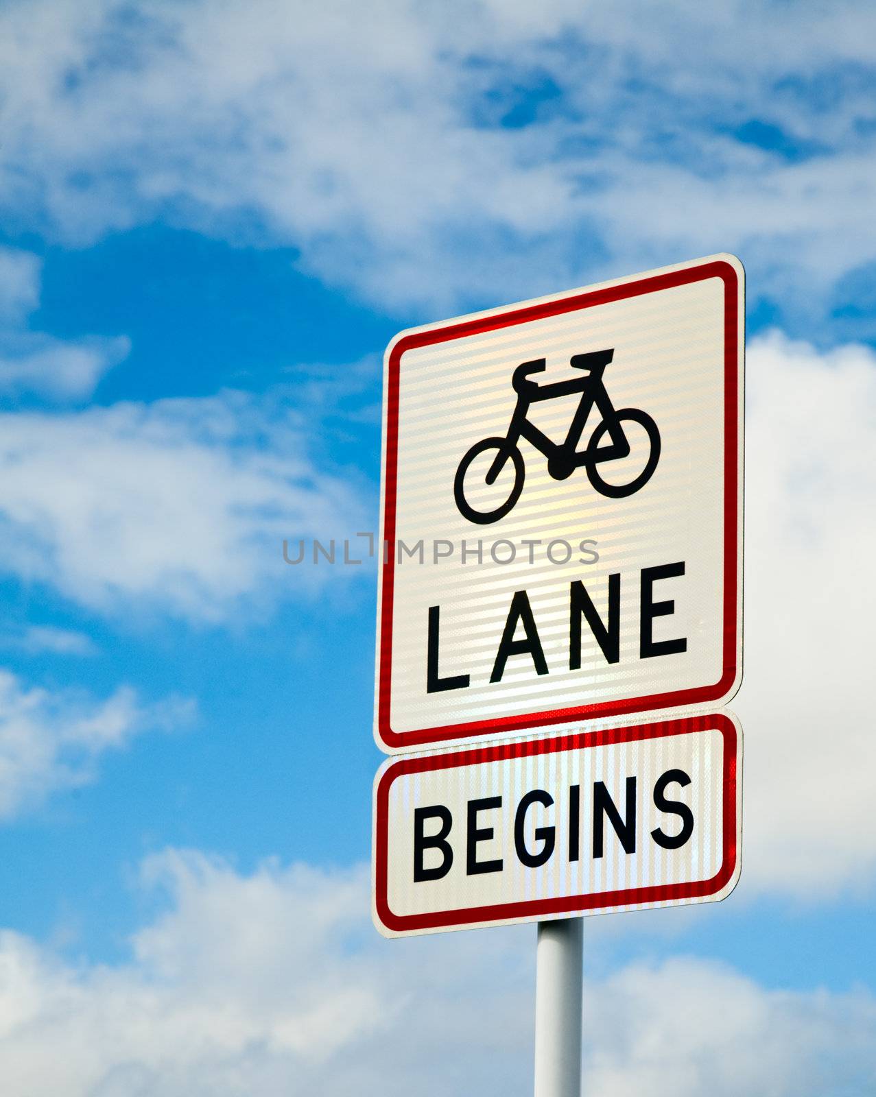 Bicycle lane sing against cloudy sky