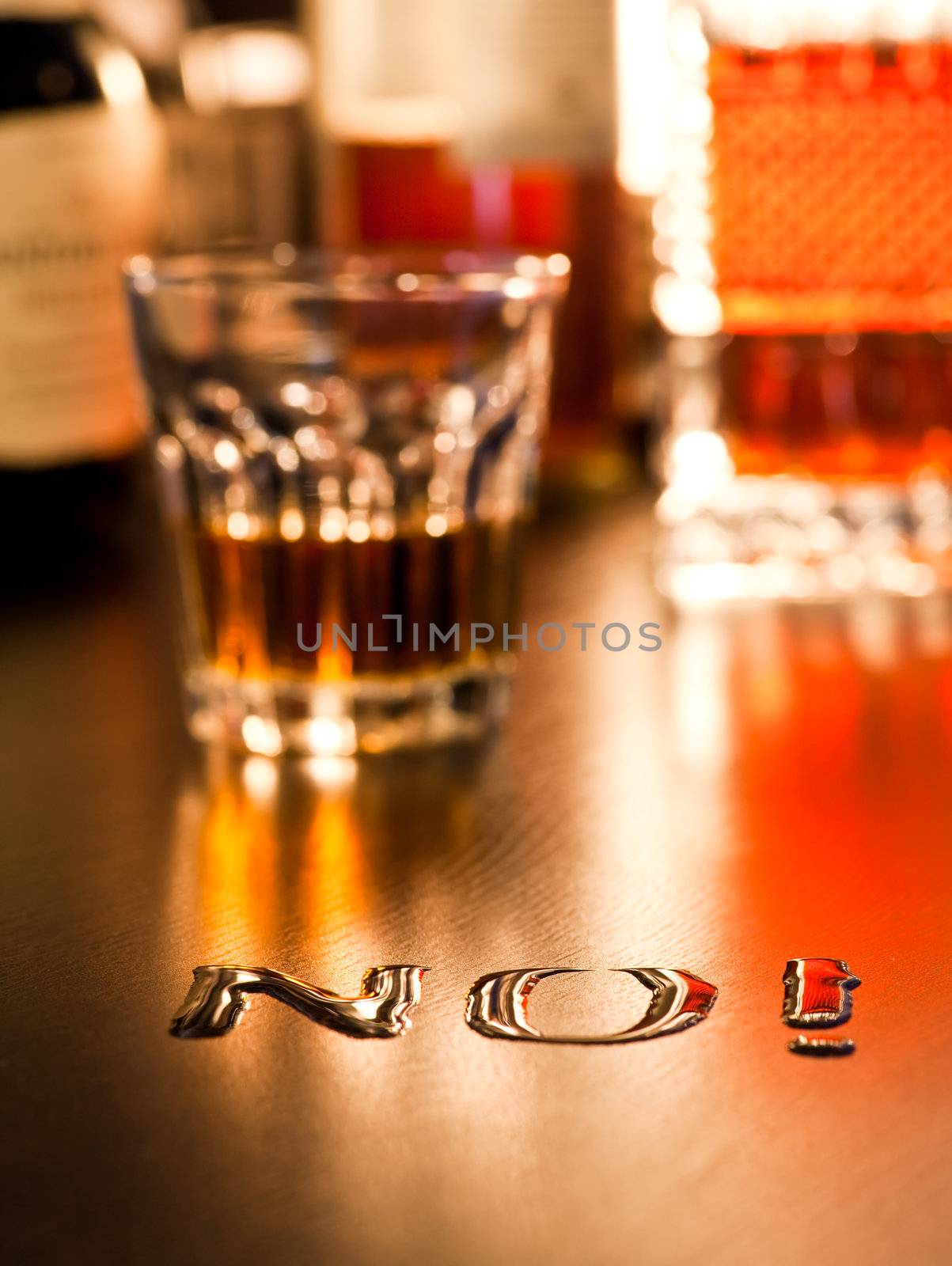 The word No written with spoiled whiskey on a table, shallow DOF