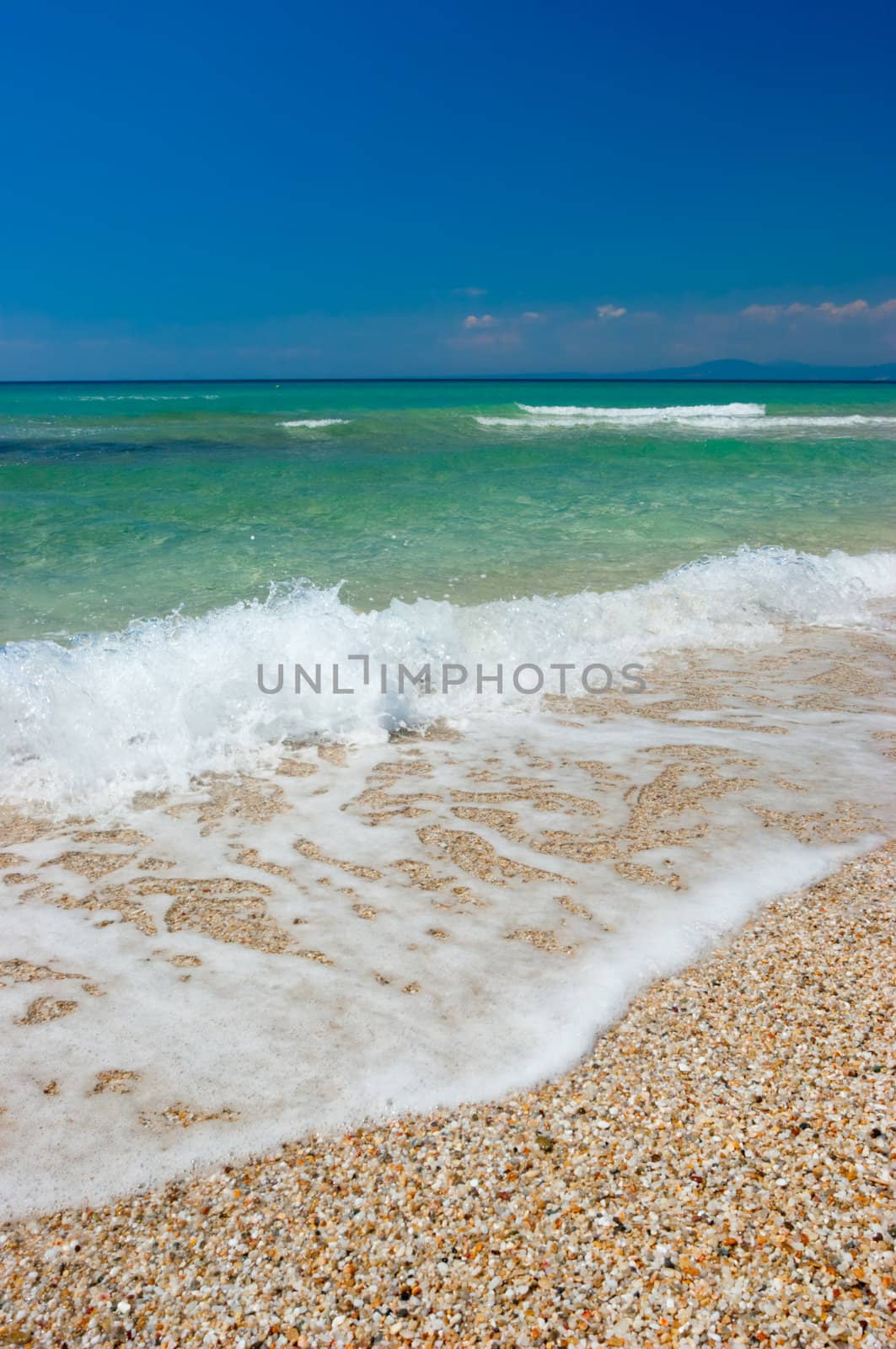 Waves on a pebbly sea shore