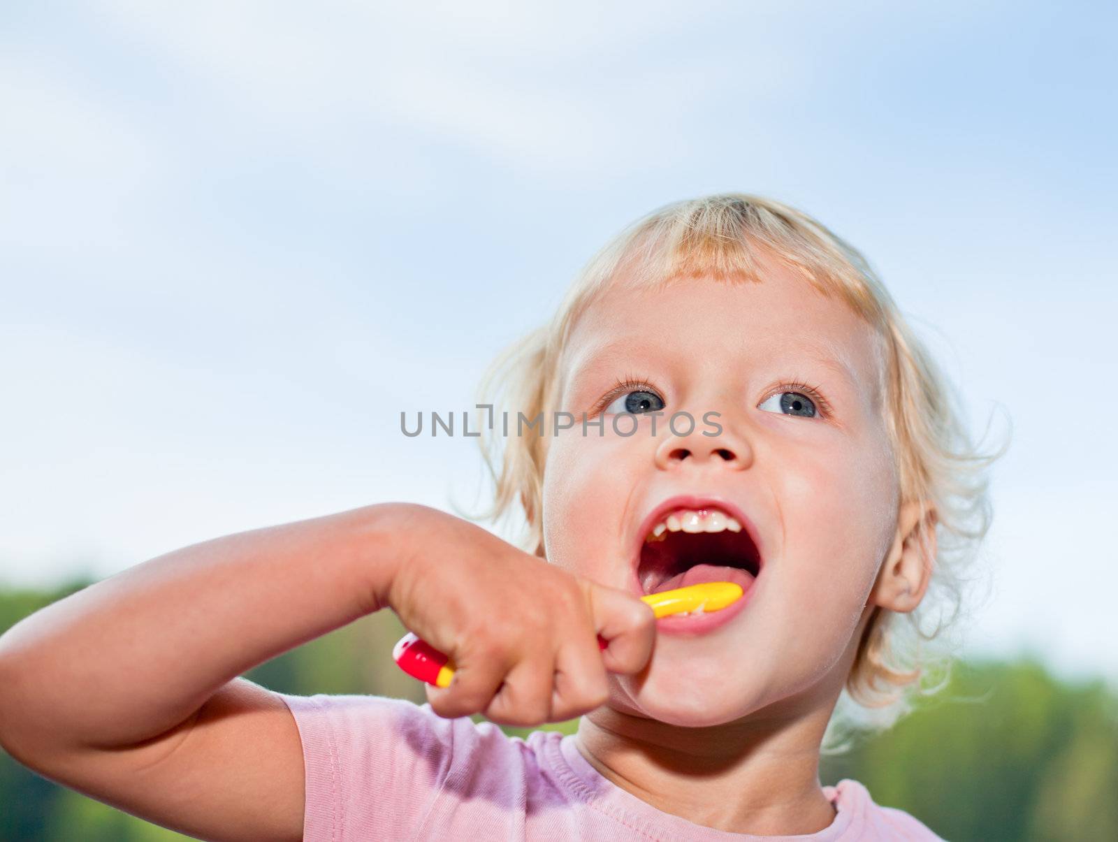 Little girl brushing teeth by naumoid