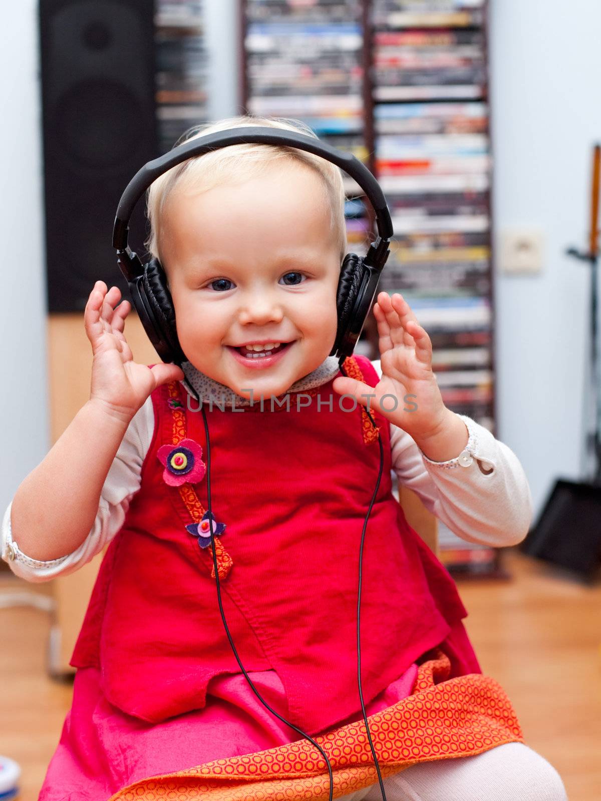 Toddler with headphones by naumoid