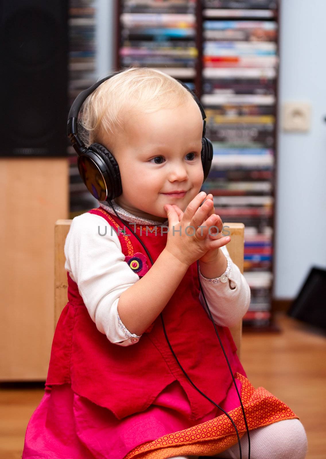 Cute baby girl listening to a music