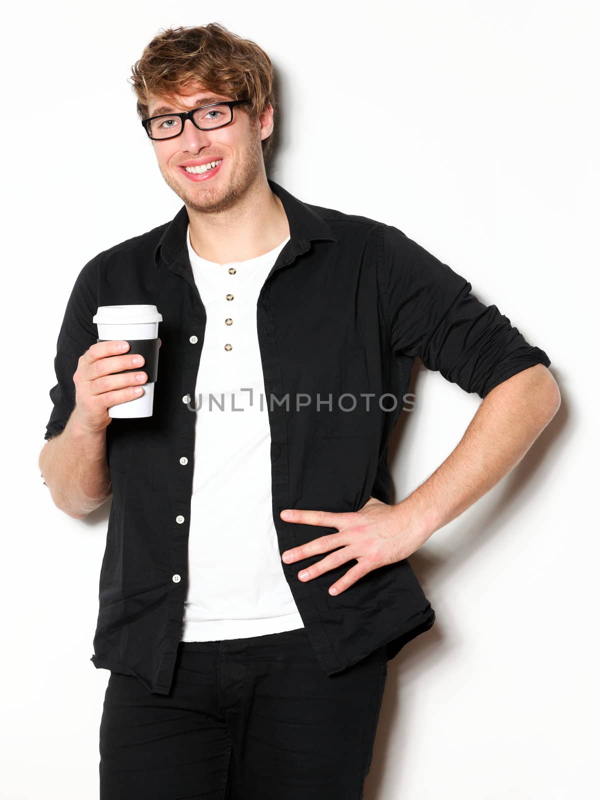 Young man drinking coffee portrait. Smiling happy male university student with drinking disposable coffee. Young male model in his twenties.