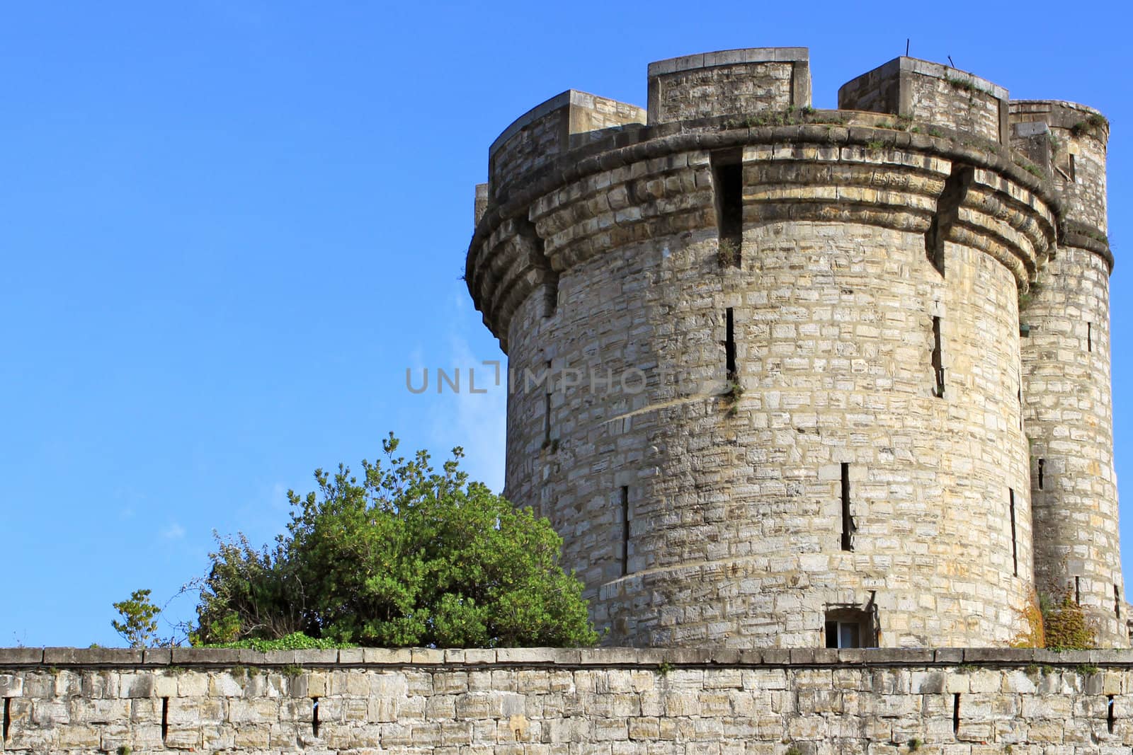 fortifications, tower and tower of a castle on blue sky background