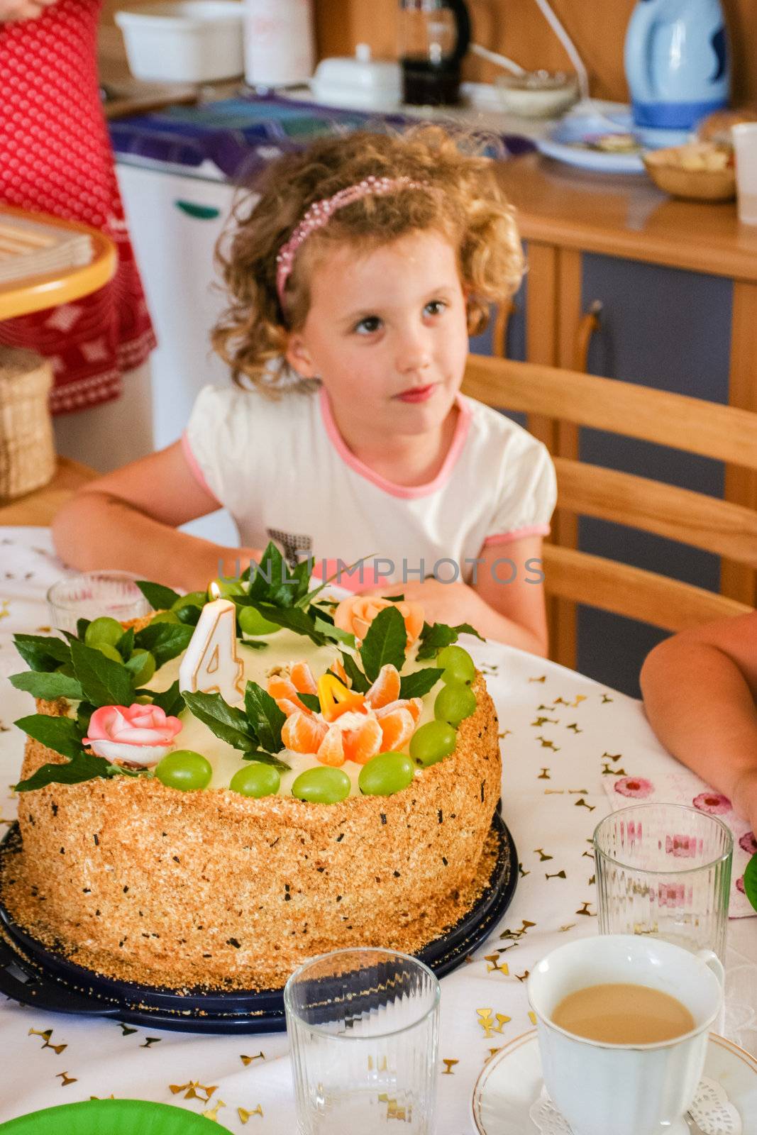 Home made round walnut birthday cake with fruits for celebrating 4th birthday.