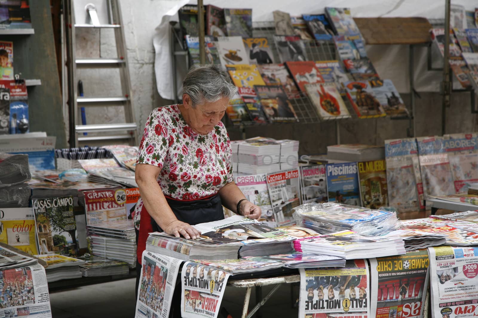 URBAN NEWSSTAND, ORVIEDO, SPAIN - SEPTEMBER 17: Senior female in her urban newsstand Orviedo, Spain on September 17, 2012.