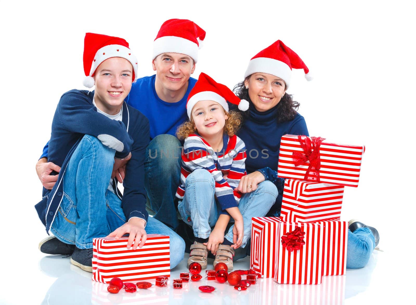 Portrait of friendly family in Santa's hat with gift box, isolated on white