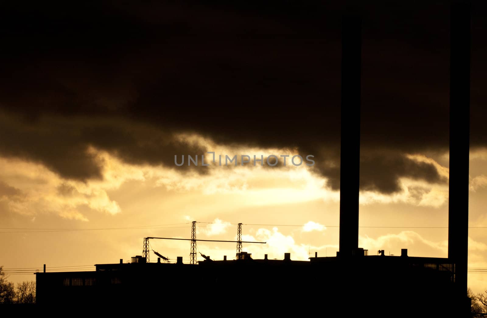 Industrial plant spewing out fumes from three chimneys 