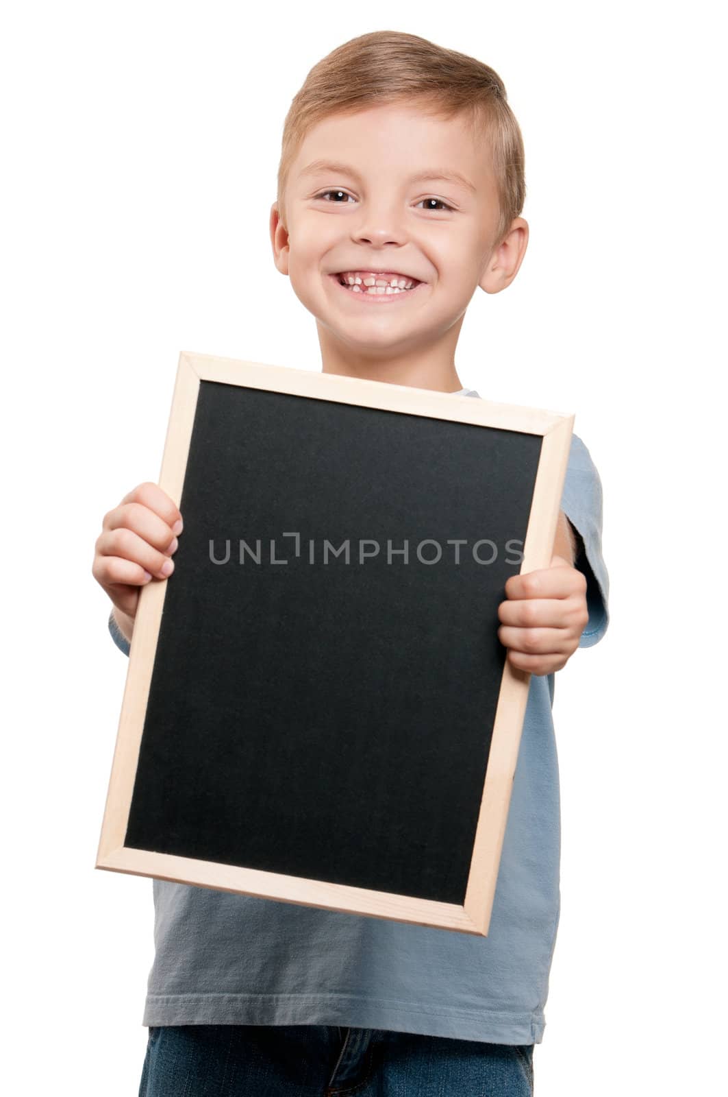 Portrait of a little boy holding a blackboard over white background