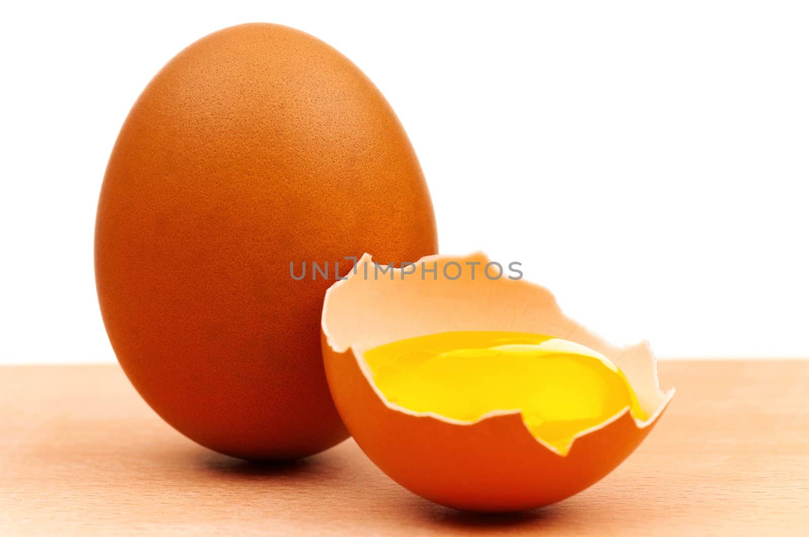 Fresh chicken eggs on wooden board over white background