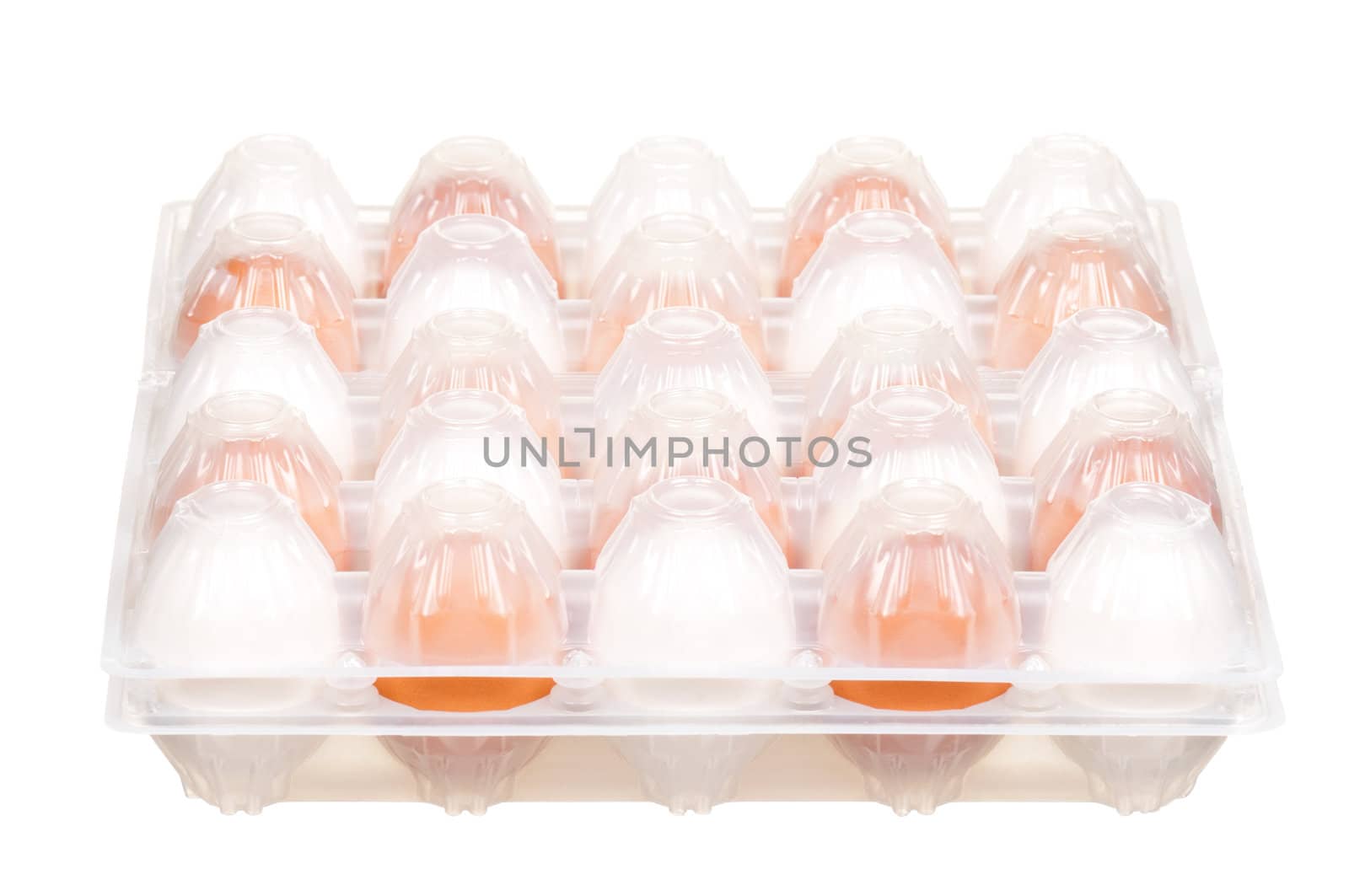 Brown and white eggs in the plastic box over white background