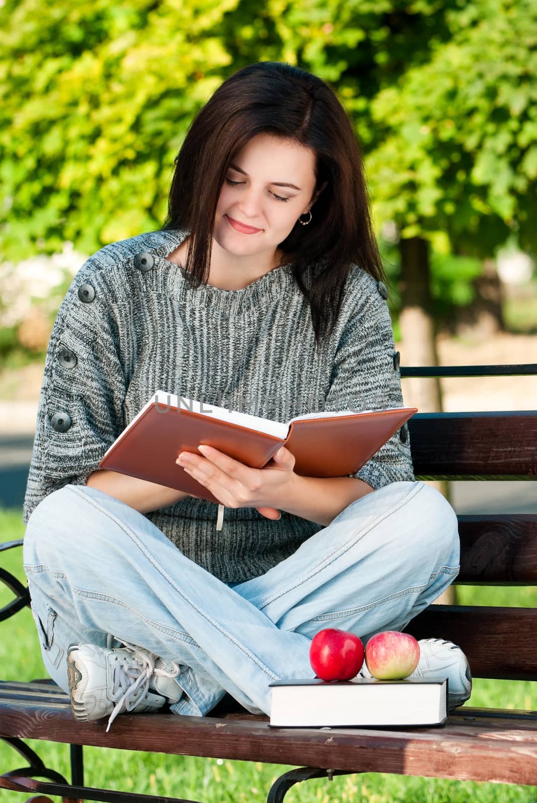 Portrait of a young female student with books at the campus