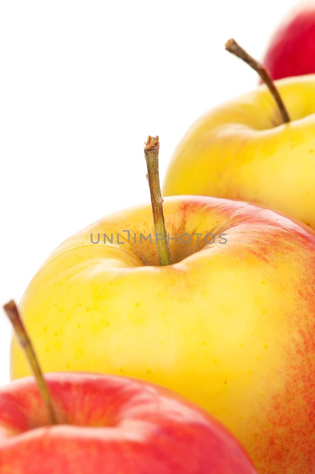 Fresh ripe red and yellow apples on white background