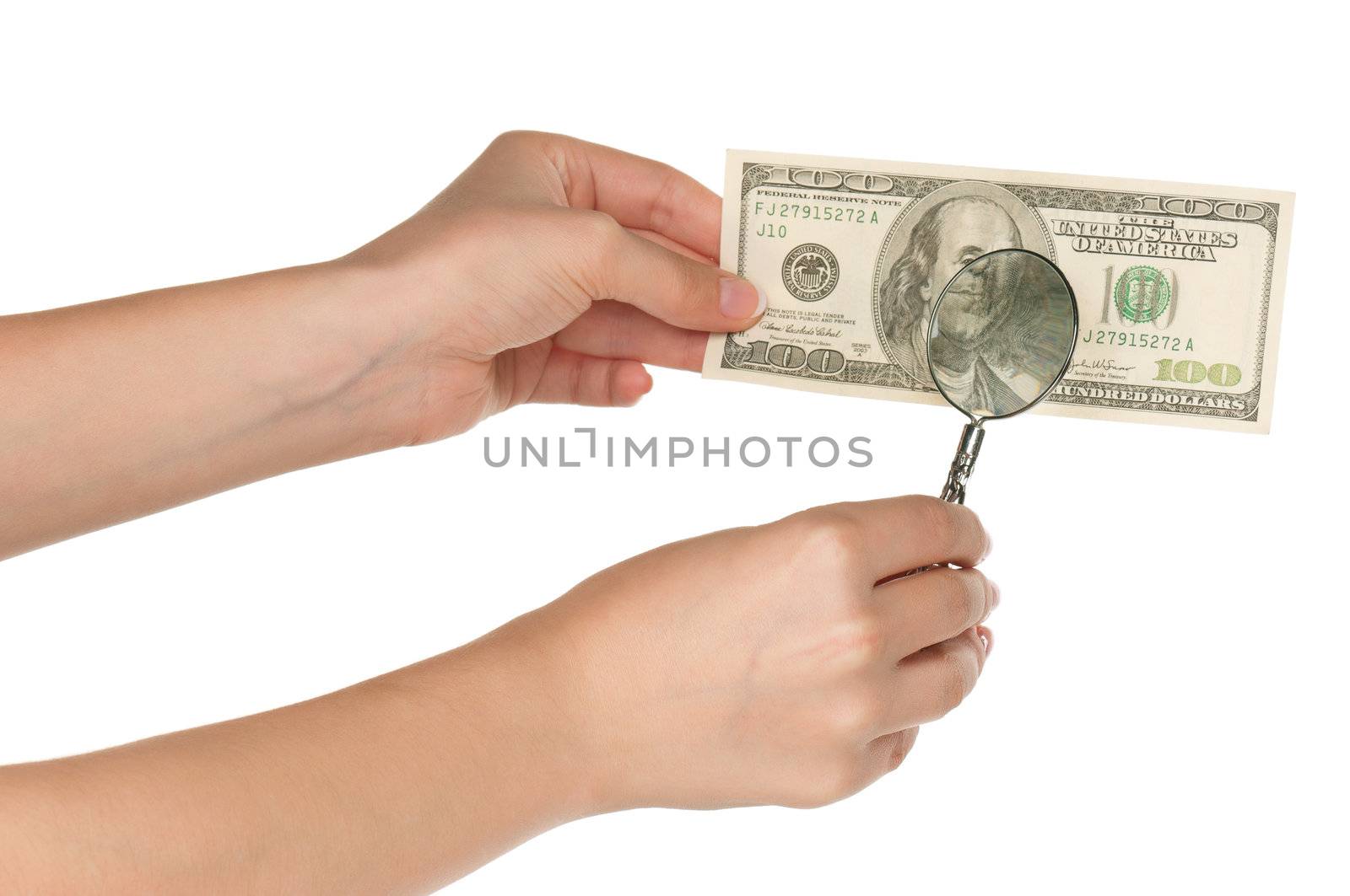 Woman hands with magnifying glass and dollars isolated on white background