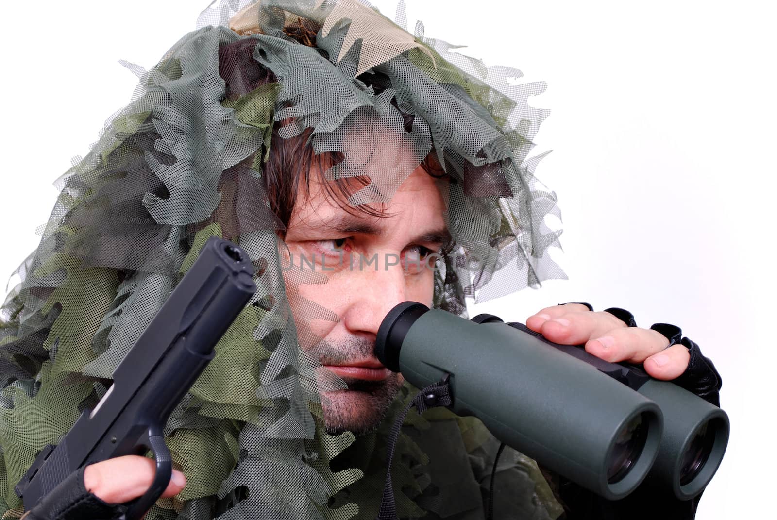 Army recon in camouflage uniform with gun