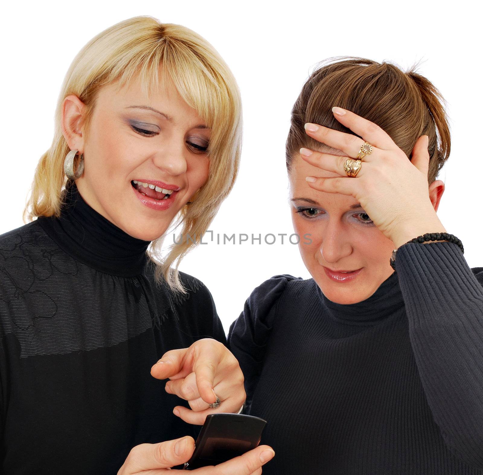 Two girls looking at the message from a mobile phone