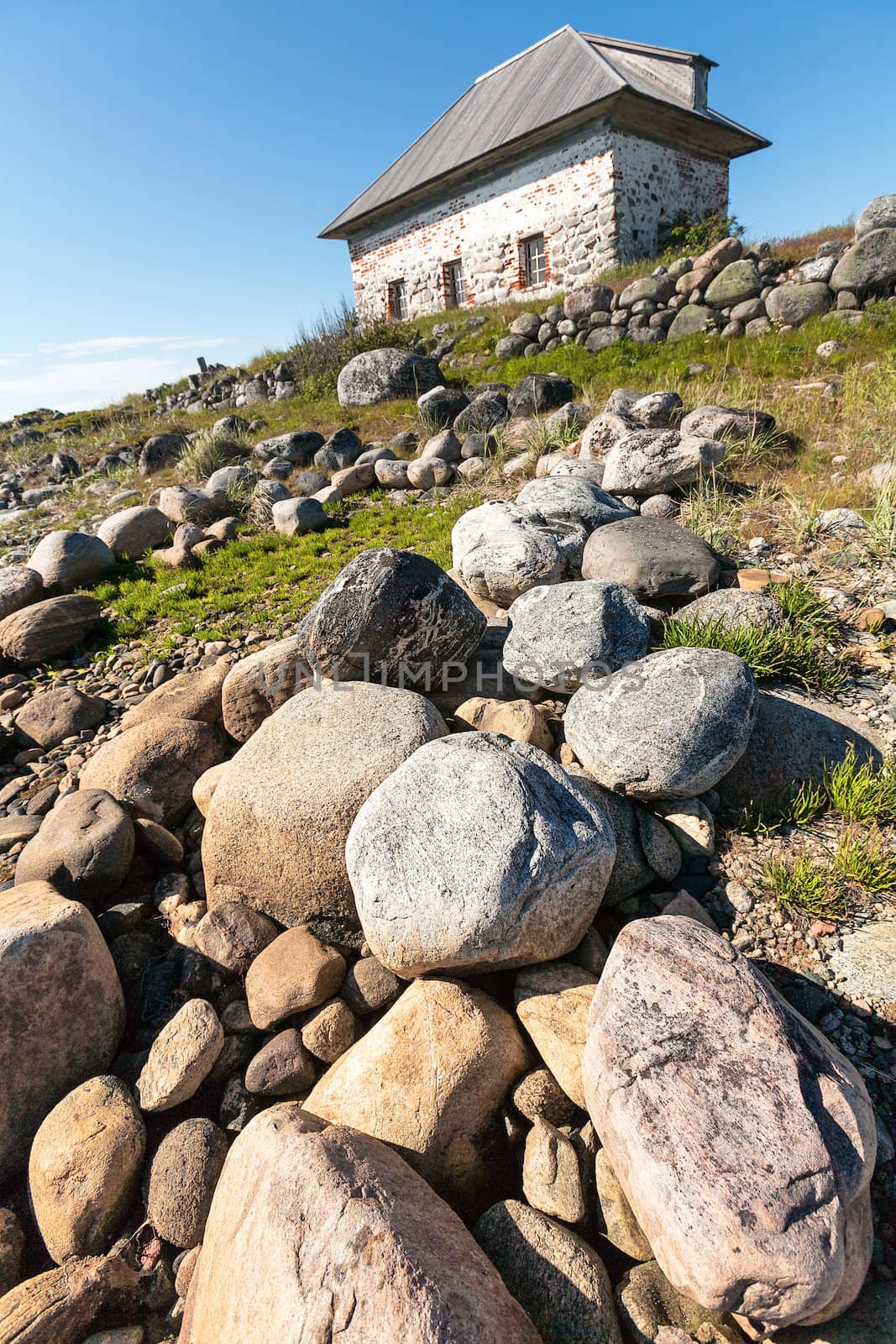 Stone house on the rocky shore. by vladimir_sklyarov
