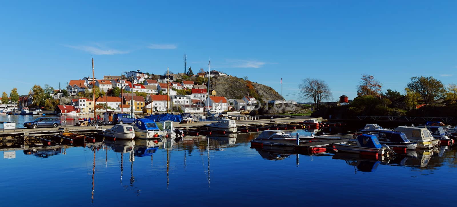 Marina. Rocky island with houses in Kragero, Norway. by teus