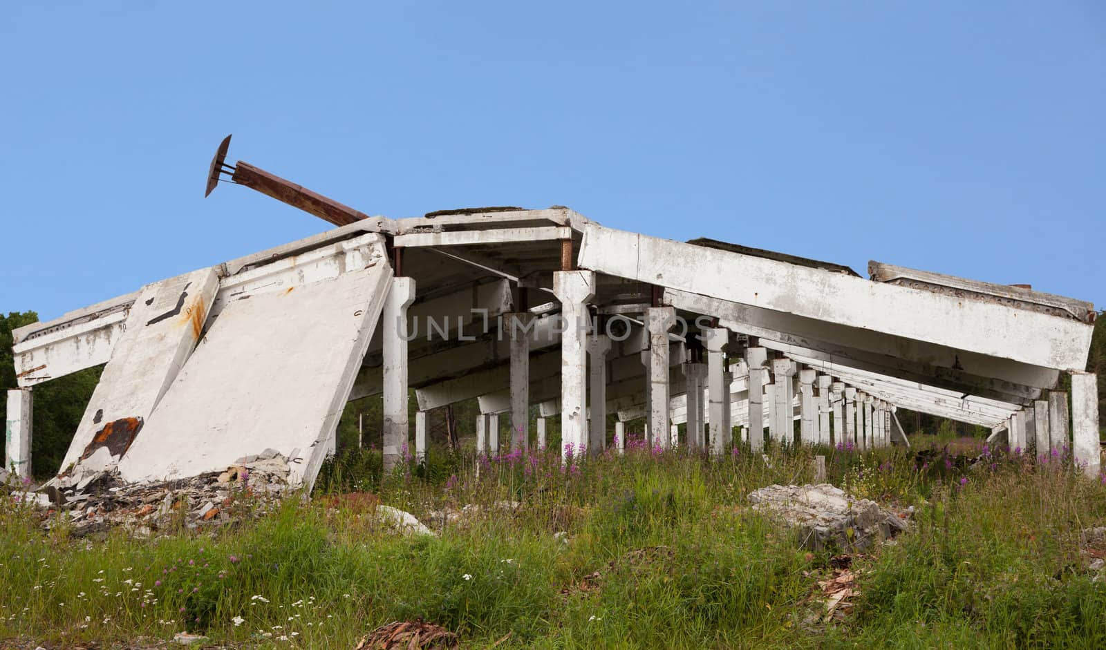 The remains of the destroyed industrial building against the blue sky