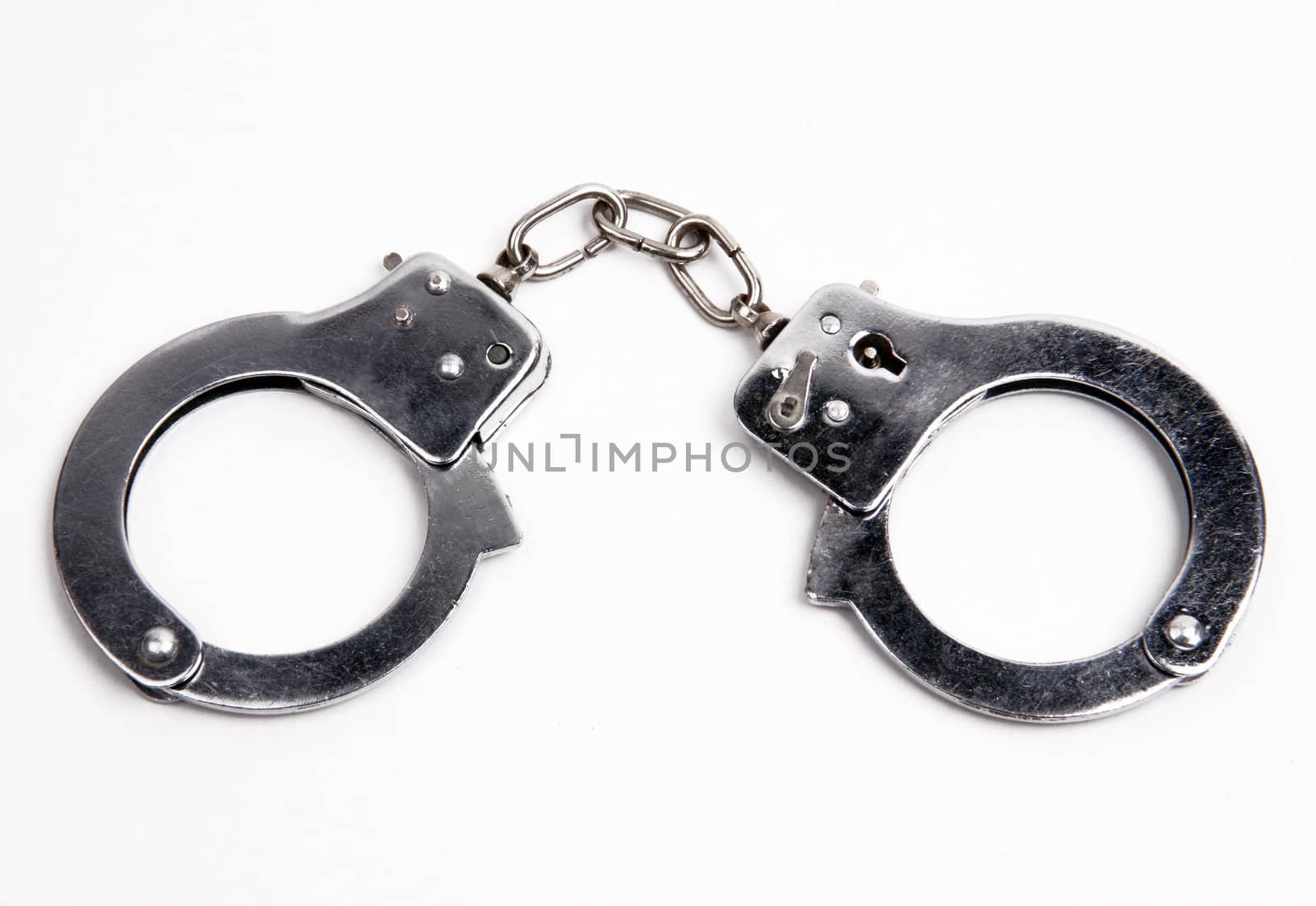 Metal handcuffs on white