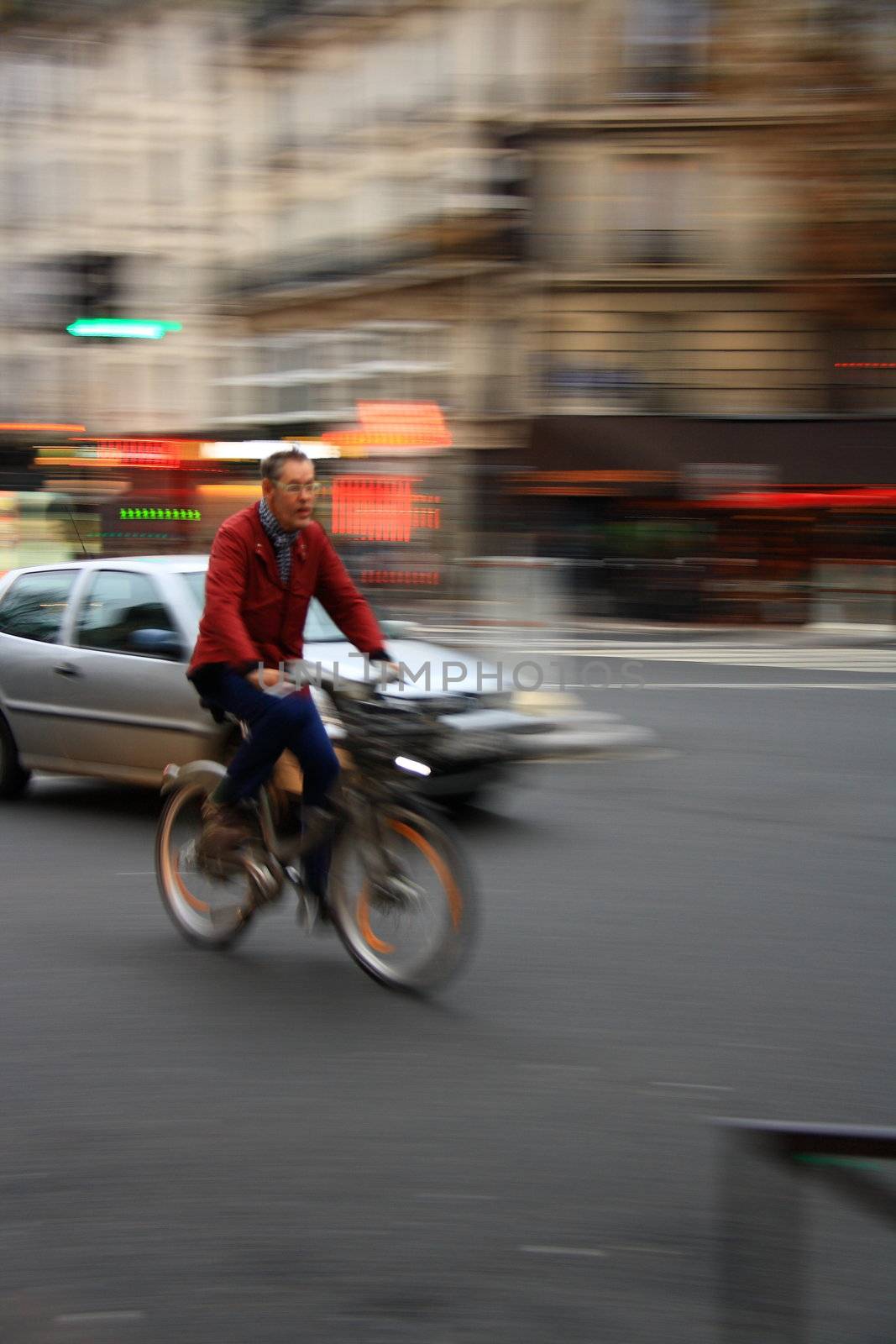 Man biking on streets of Paris with helmet 