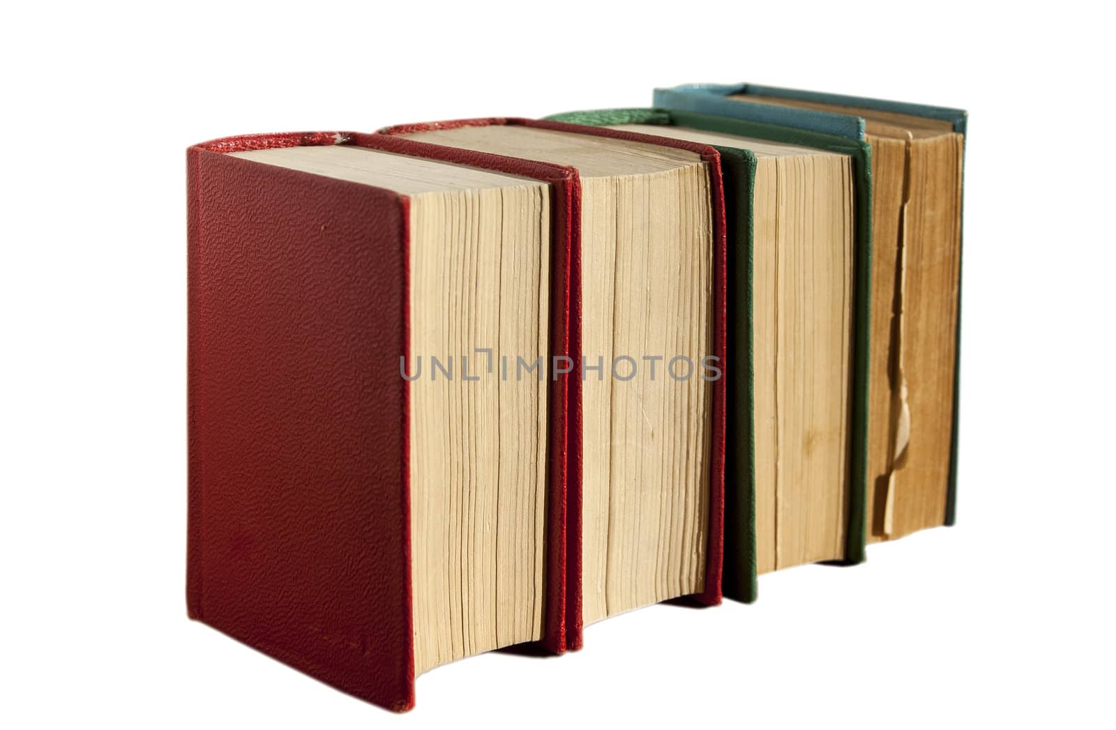 Four old books in row isolated on white