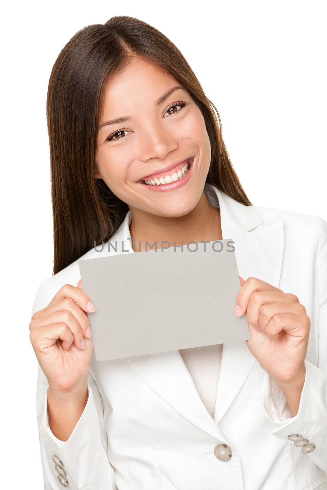 Vivacious beautiful young Asian woman with a beaming smile holding up a small grey card for your attention and text isolated on white