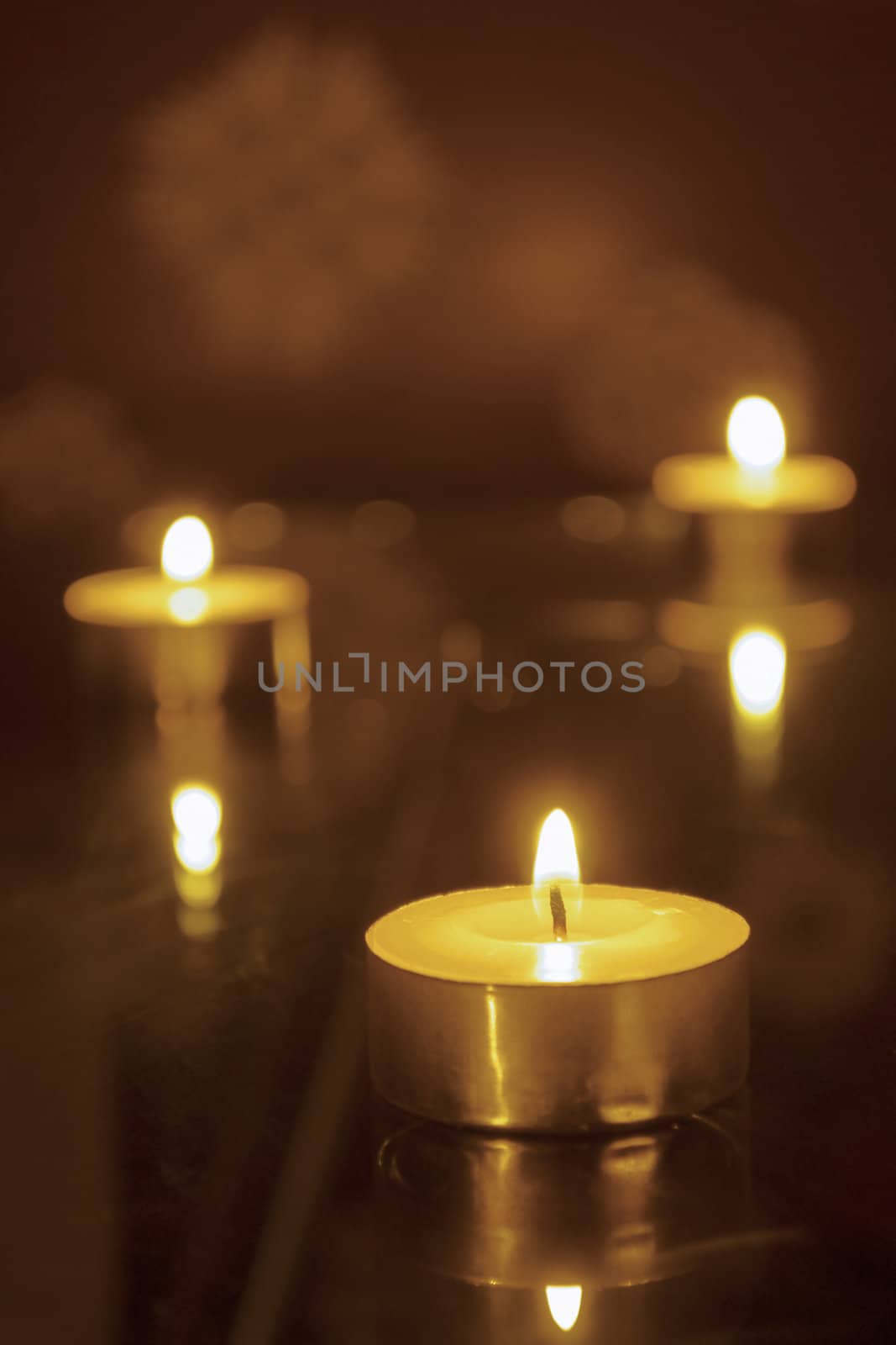 three candles light, shallow DOF; focus on front candle