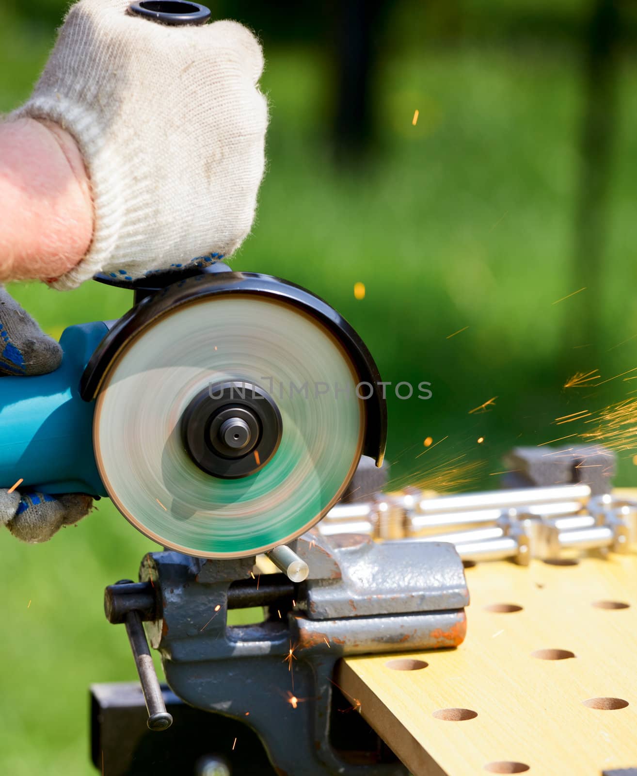 Man cutting metal with angle grinder