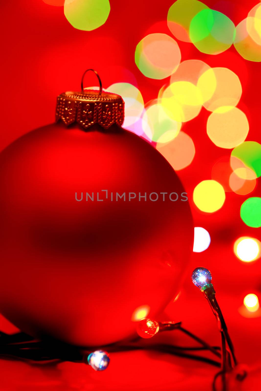 Red Christmas bauble with blured lights in background