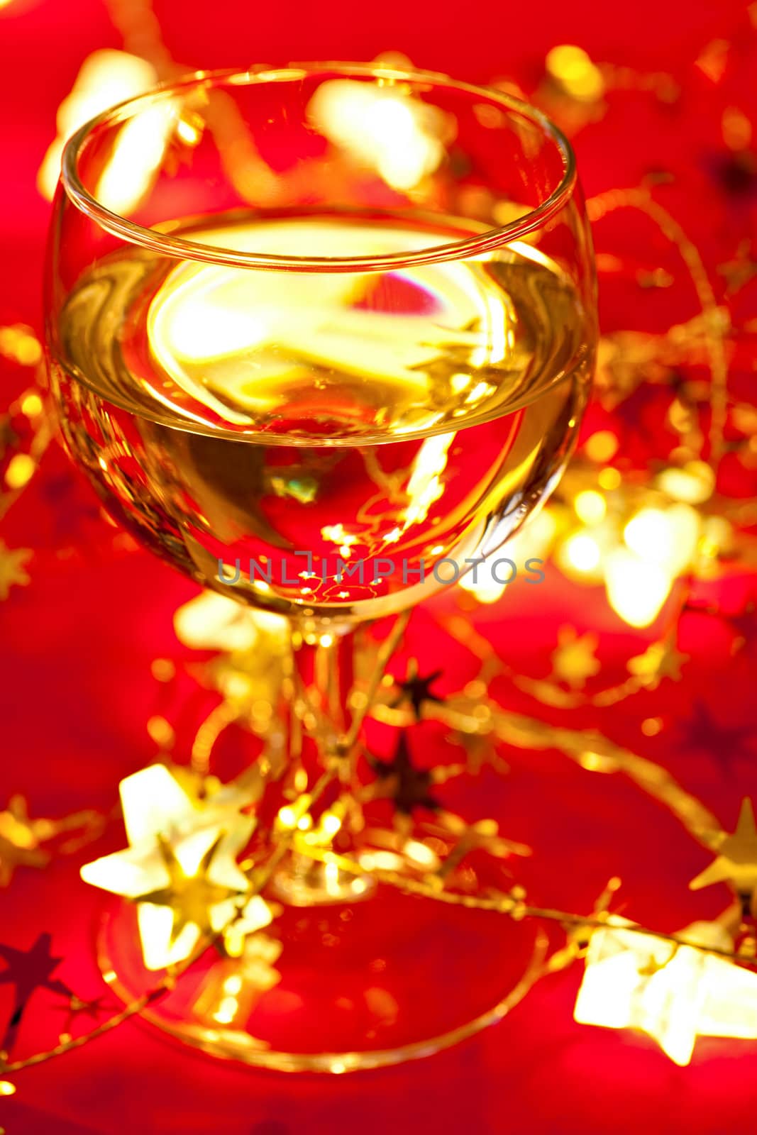 Glass of white wine with Christmas decoration, very shallow DOF