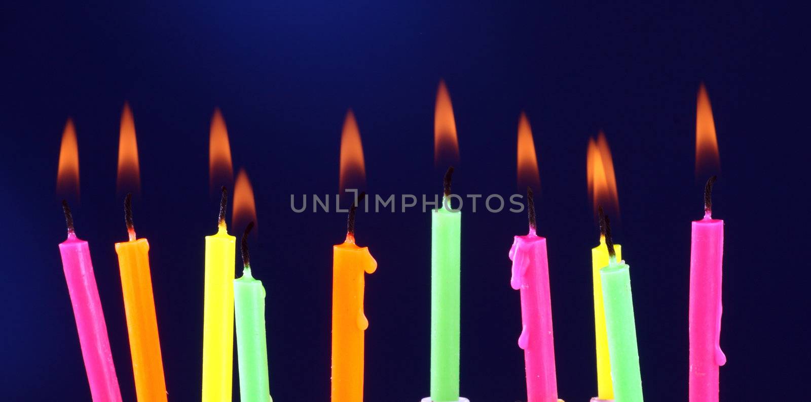 Some lit birthday candles close up 