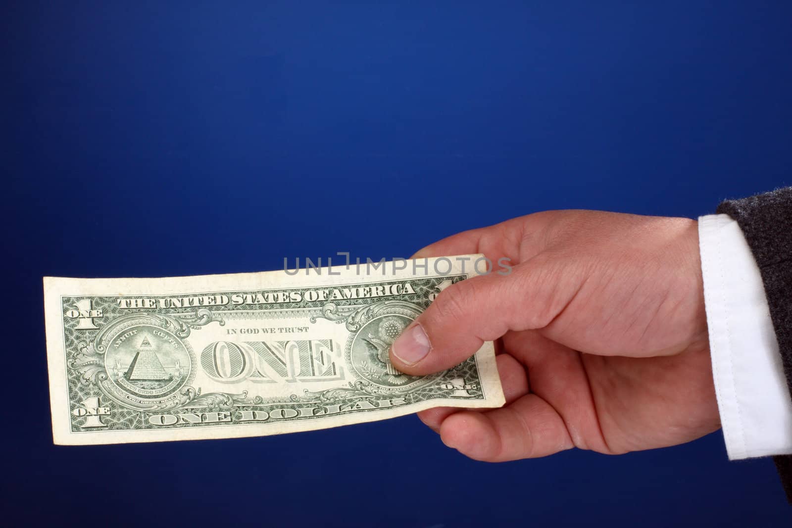  male hand holding a one dollar bill
