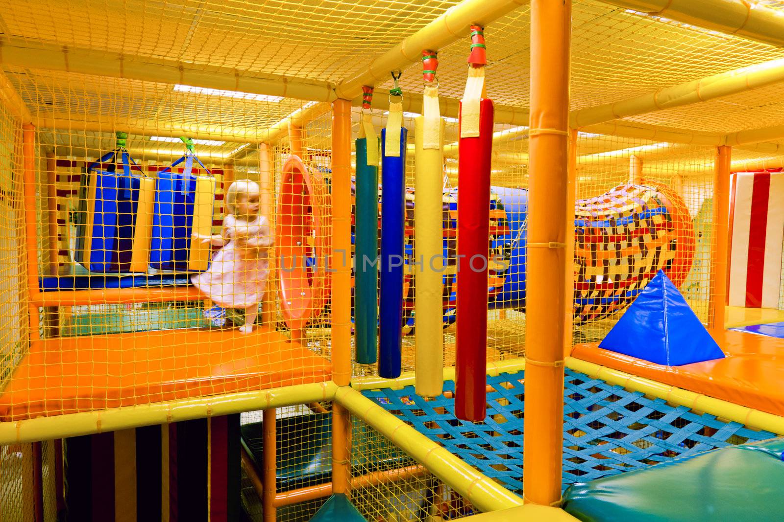 Little girl playing inside of maze playground